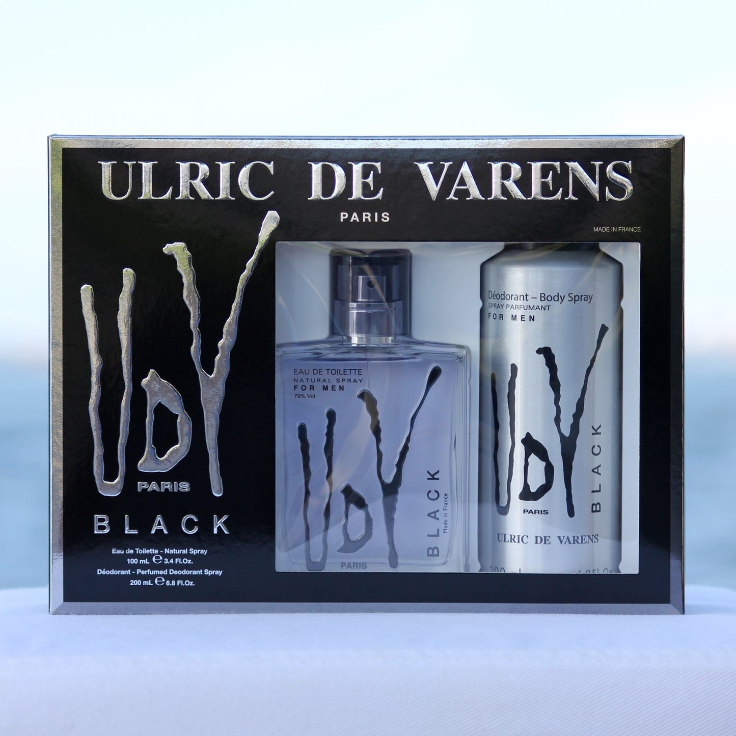 Ulric De Varens UDV Black Gift Set men's perfume 3.4 EDT and deodorant 6.8 oz in front of beach