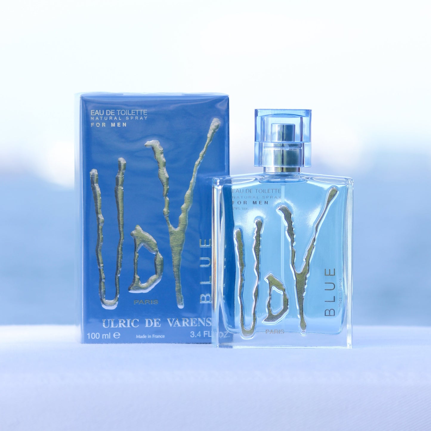 Ulric De Varens UDV Blue men's perfume 3.4 EDT in front of beach