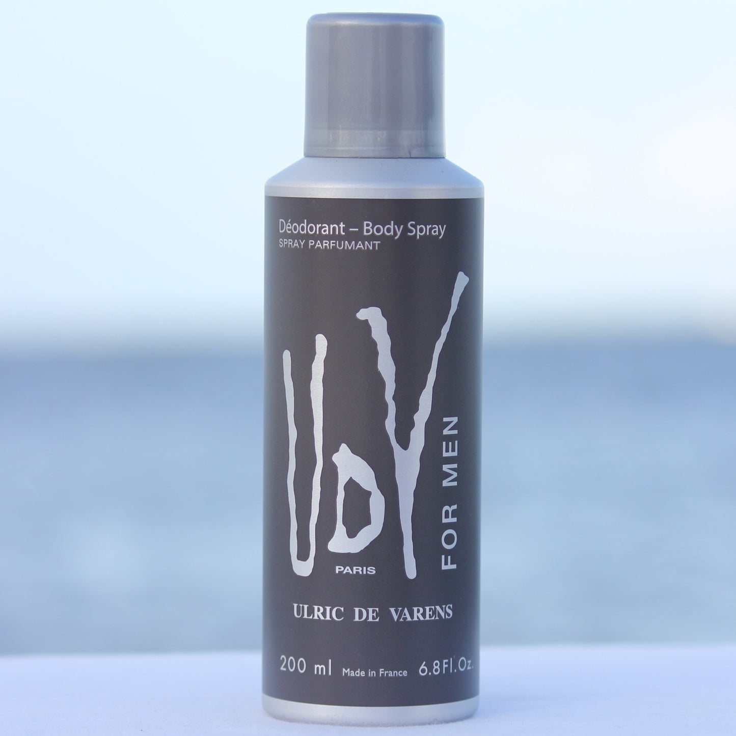 Ulric De Varens UDV For Men perfume scented deodorant 6.4 oz in front of beach