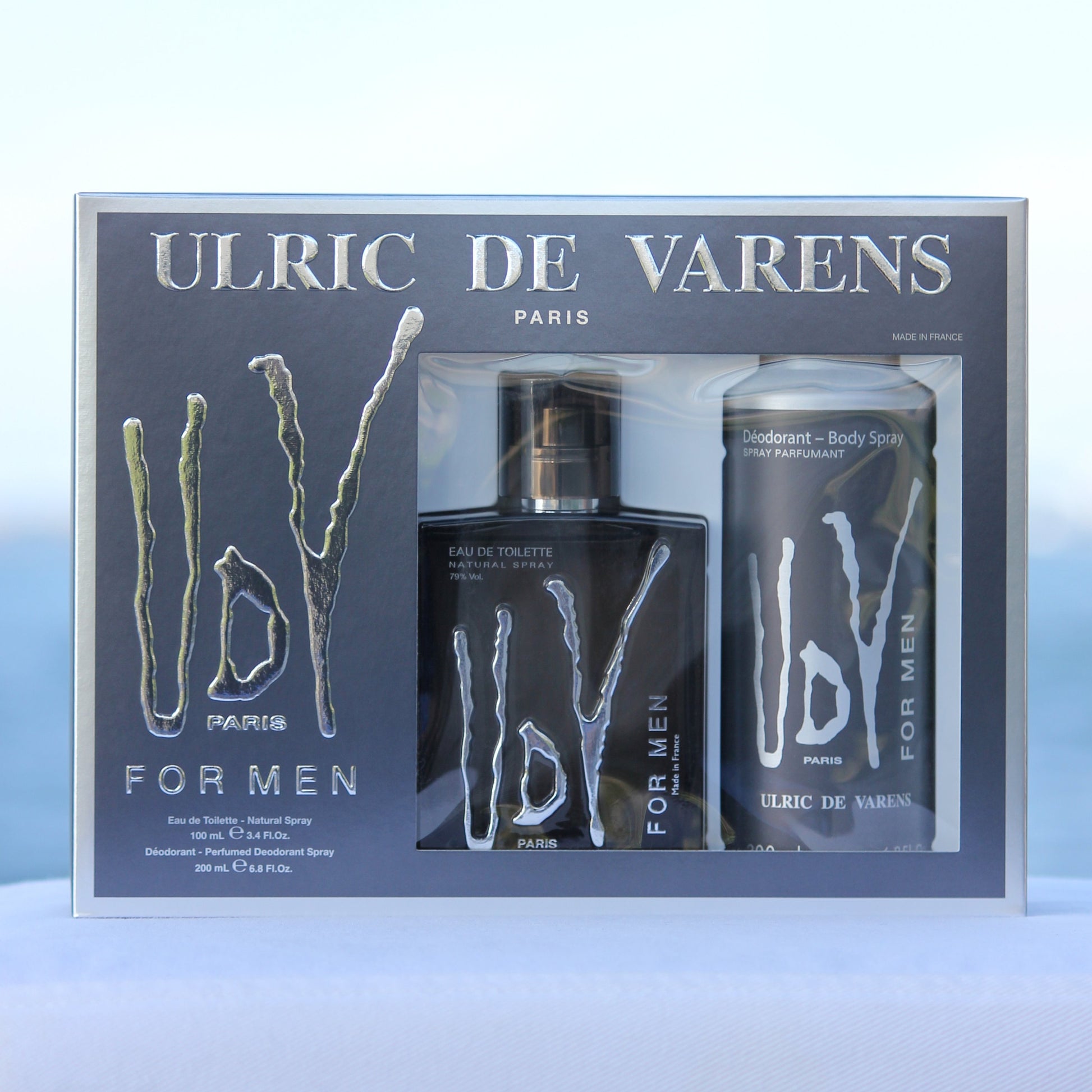 Ulric De Varens UDV For Men Gift Set perfume 3.4 EDT and deodorant 6.8 oz in front of beach