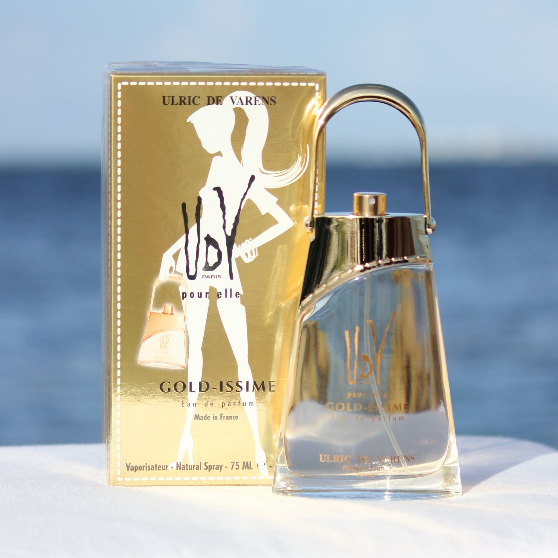 Ulric De Varens Gold-issime women's inexpensive perfume 2.5 EDP in front of beach