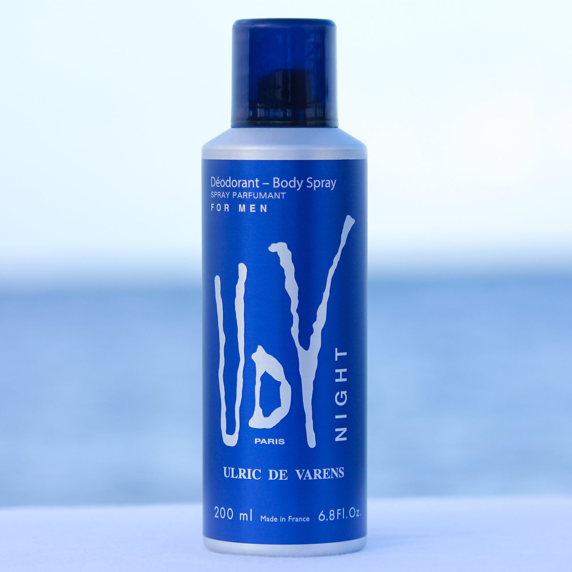 Ulric De Varens UDV Night men's perfume scented deodorant 6.4 oz in front of beach