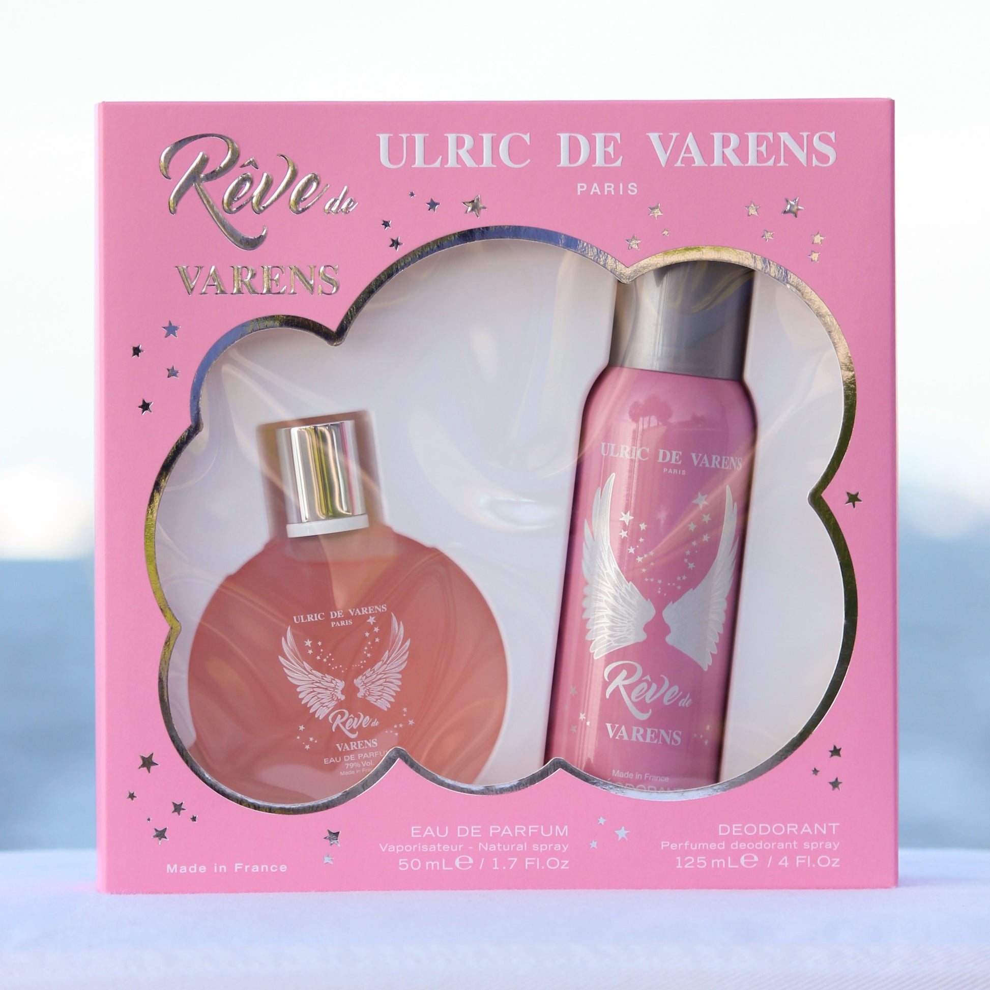 Ulric De Varens Reve De Varens Gift Set women perfume 1.7 EDP and deodorant 4 oz in front of beach