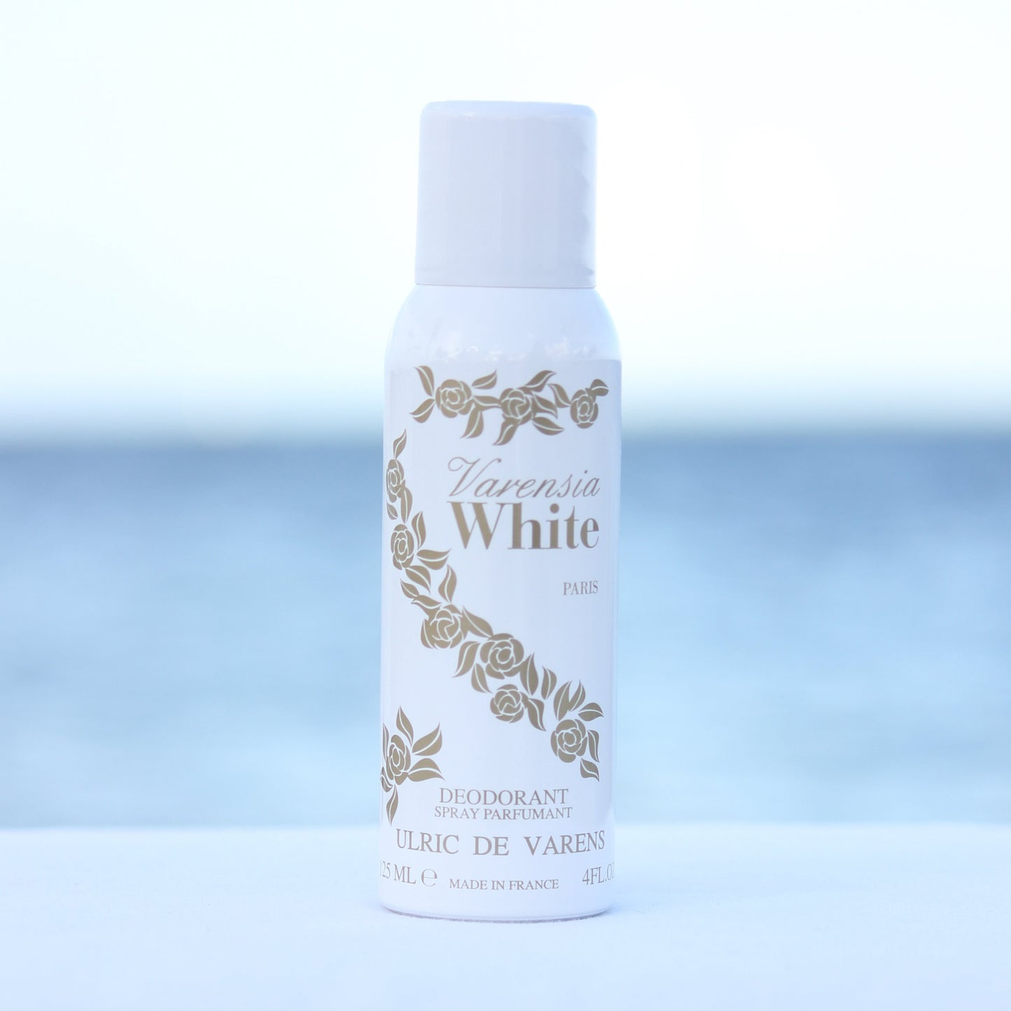 Ulric De Varens Varensia White women's perfume scented deodorant 4 oz in front of beach